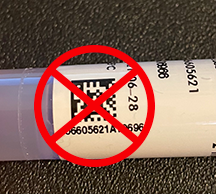 QR code on the side of a test specimen vial marked with a red "X" 