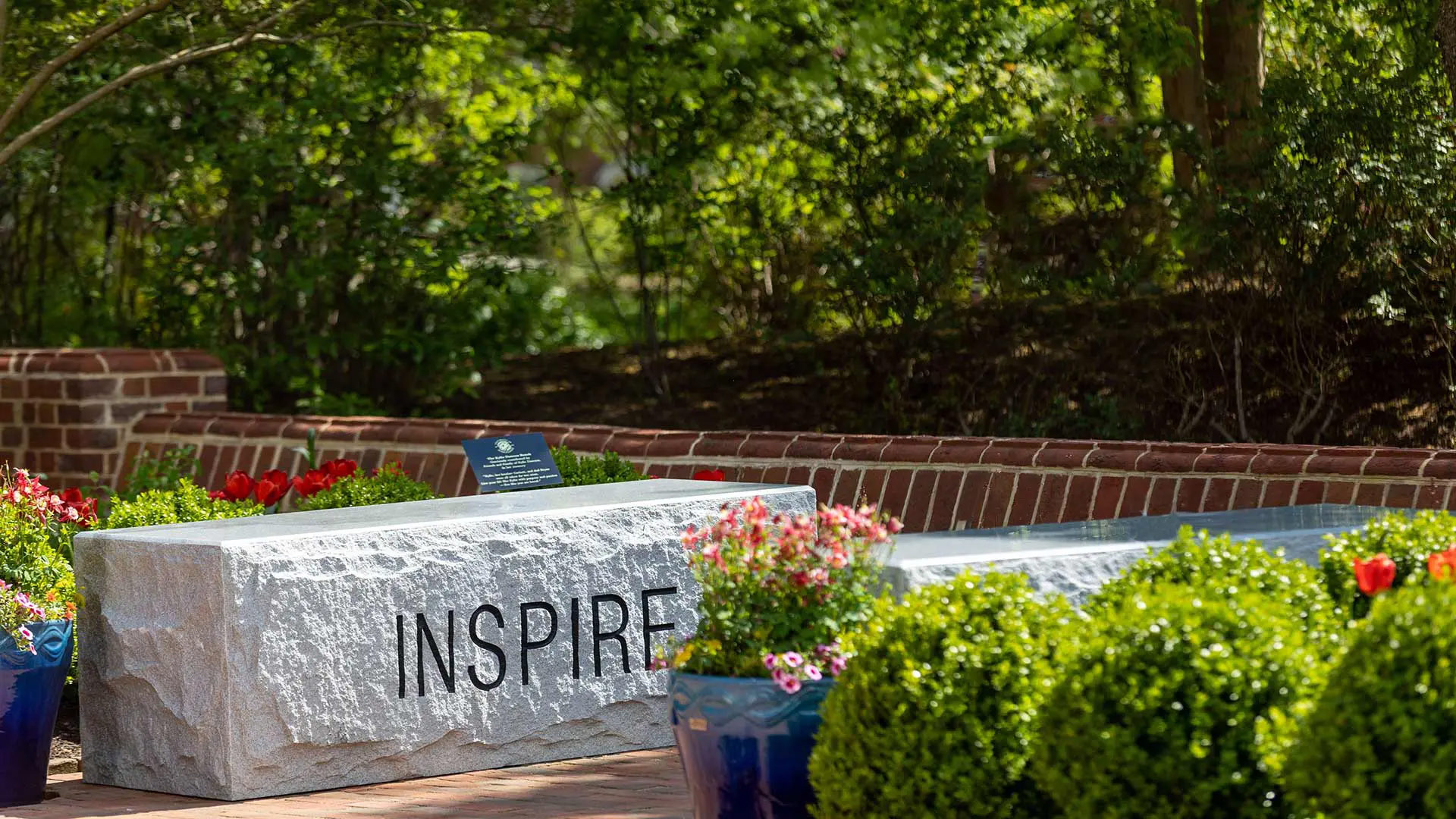 Granite benches engraved with words related to dialogue are the primary features of the new Listening Garden behind Memorial Chapel. The bench etched with the word "inspire" honors the memory of late UMD student Kylie Dawson. Photo by Riley N. Sims Ph.D '23.