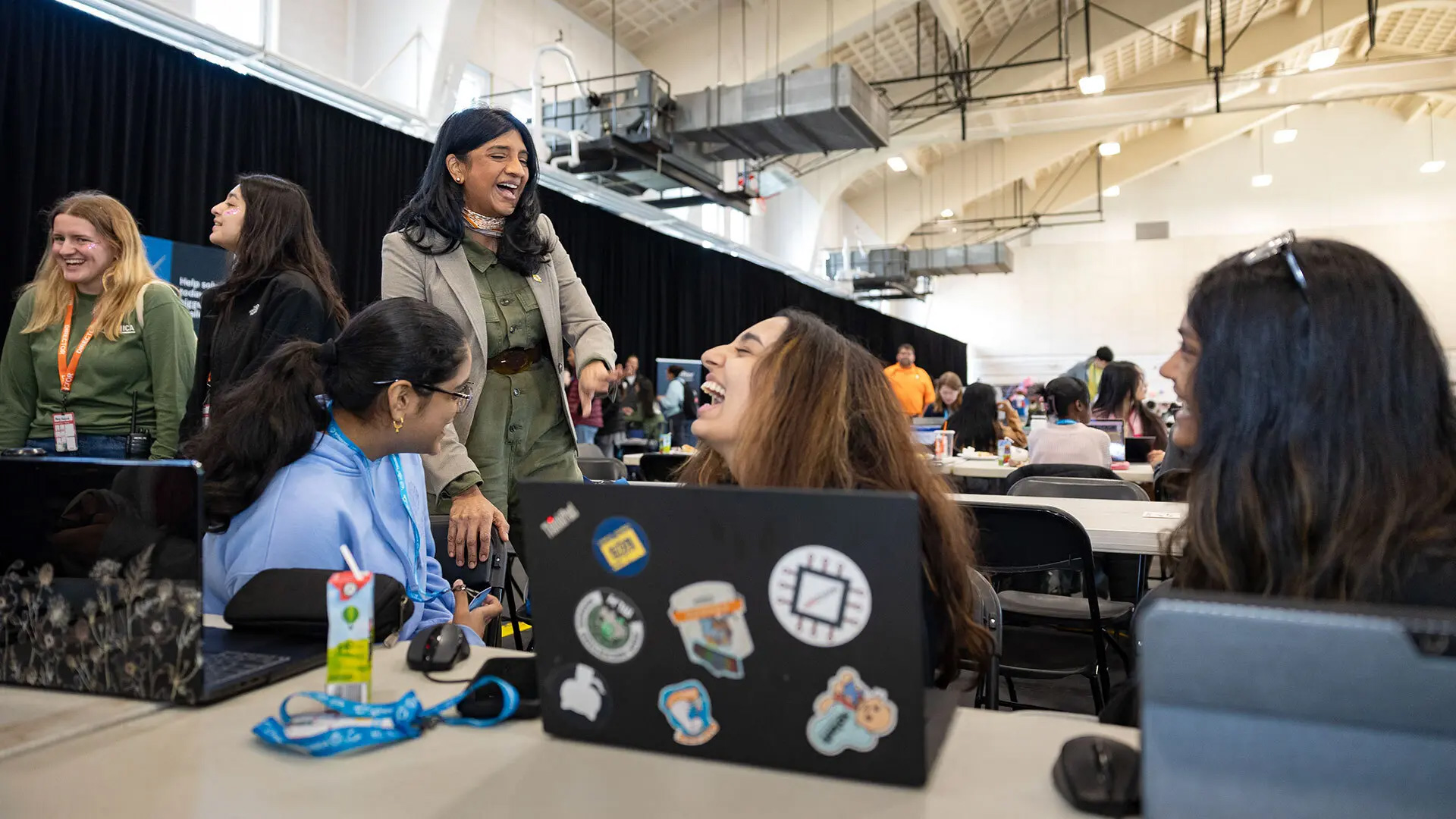 Lt. Gov. Aruna Miller talks at Technica with the South Brunswick, N.J.-based team of (from left) Bhavya Tanugula ’28, South Brunswick High School senior Anika Thakur and Esha Vigneswaran ’28. The trio developed an app called “Locked In,” which aims to help students focus on homework by blocking users from accessing distracting websites and providing warnings to users when their eye movements stray from their computer screens.